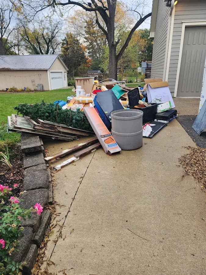 Dumpster being loaded with debris for Estate Cleanout Dumpster Rental in Mahtomedi